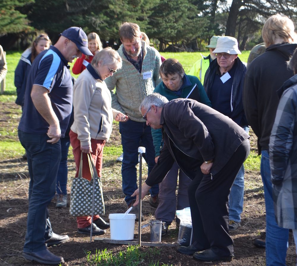 Doug Philips (Greening Australia) and Dion Borg (GHCMA) show the group the Biochar demonstration site